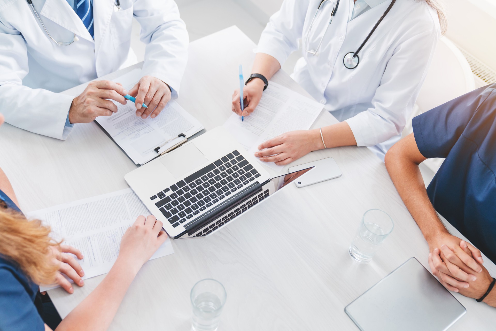 Top view of successful medical doctor team discussing diagnosis during the conference in meeting room